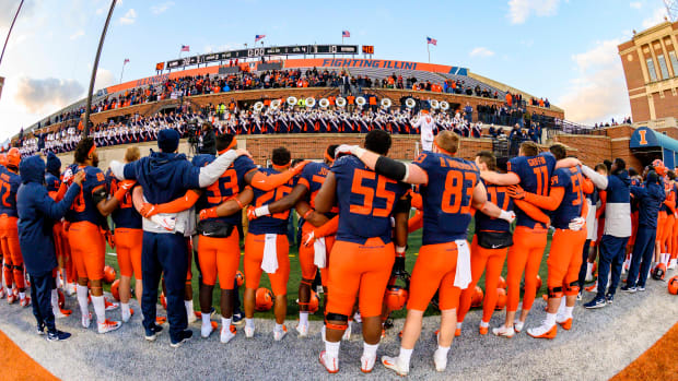 The Illinois Fighting Illini celebrate after a victory over the Rutgers Scarlet Knights at Memorial Stadium.