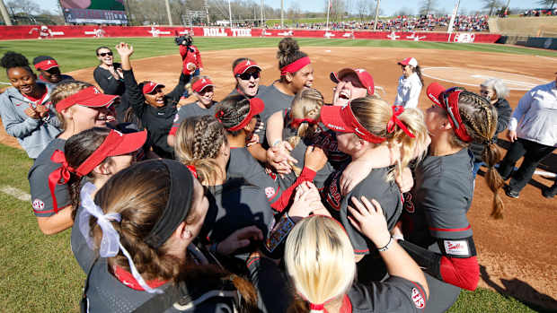 Alabama softball player Bailey Hemphill tries to hug her entire team on her senior day