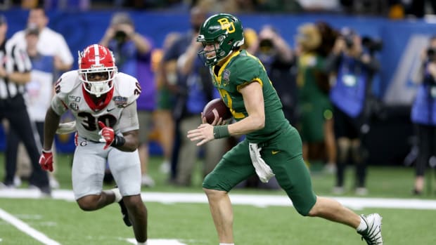 Jan 1, 2020; New Orleans, Louisiana, USA; Baylor Bears quarterback Charlie Brewer (12) runs from pressure by the Georgia Bulldogs linebacker Tae Crowder (30) in the second half of the Sugar Bowl at the Mercedes-Benz Superdome.