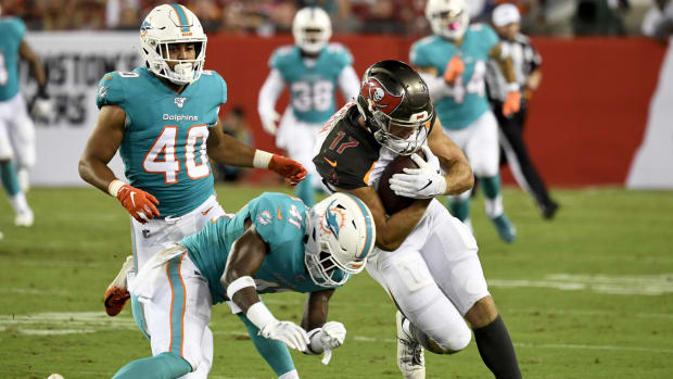 Tampa Bay Buccaneers wide receiver Justin Watson (17) runs with the ball as Miami Dolphins defensive back Montre Hartage (41) defends during the fourth quarter at Raymond James Stadium.