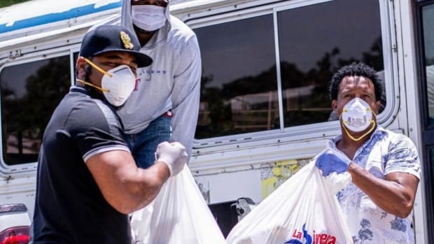 Edwin Encarnacion and Pedro Martinez distribute supplies to communities in the Dominican Republic.