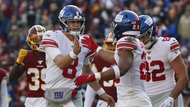 Dec 22, 2019; Landover, Maryland, USA; New York Giants quarterback Daniel Jones (8) celebrates with Giants running back Saquon Barkley (26) after connecting on a touchdown pass against the Washington Redskins in the second quarter at FedExField.