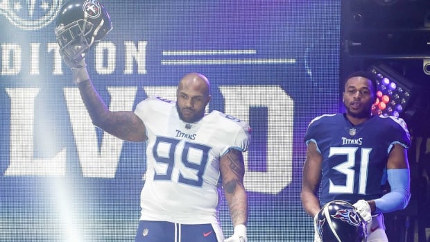 Tennessee Titans defensive tackle Jurrell Casey (99), safety Kevin Byard (31), linebacker Brian Orakpo (98), show off their new uniforms during the Titans uniform reveal event held at Broadway and 1st Avenue.