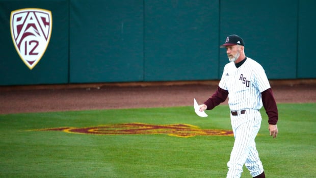 ASU baseball head coach Tracy Smith walking across the field.