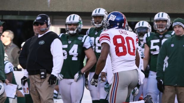 East Rutherford, New Jersey -- December 24, 2011 --- New York Giants vs New York Jets -- Victor Cruz runs past the Jets sideline as he scores a 99 yard touchdown pass in the first half.