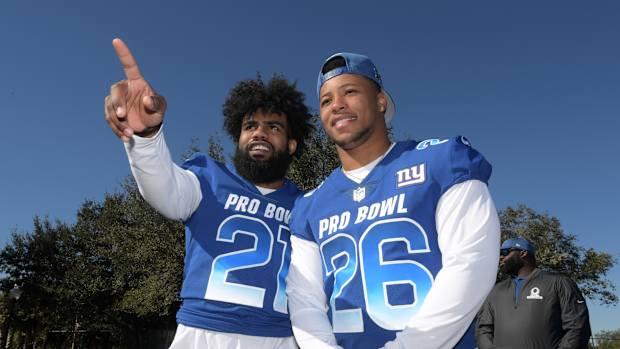 Jan 25, 2019; Kissimmee, FL, USA; Dallas Cowboys running back Ezekiel Elliott (26) and New York Giants running back Saquon Barkley (26) pose during NFC practice at ESPN Wide World of Sports Complex.
