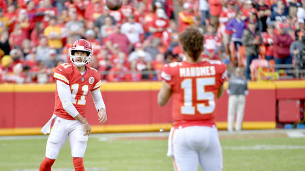 Nov 26, 2017; Kansas City, MO, USA; Kansas City Chiefs quarterback Alex Smith (11) throws passes to quarterback Patrick Mahomes (15) on the sidelines during the second half against the Buffalo Bills at Arrowhead Stadium. Mandatory Credit: Denny Medley-USA TODAY Sports