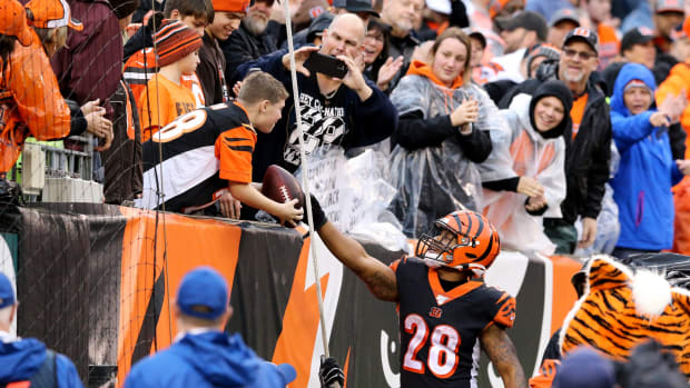 Cincinnati Bengals running back Joe Mixon (28) hands the ball to a fan after scoring a touchdown in the fourth quarter during an NFL Week 17 game against the Cleveland Browns, Sunday, Dec. 29, 2019, at Paul Brown Stadium in Cincinnati. Cincinnati Bengals won 33-23. Cleveland Browns At Cincinnati Bengals Football 12 29 2019