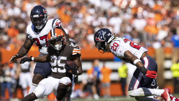 Sep 19, 2021; Cleveland, Ohio, USA; Cleveland Browns running back Demetric Felton (25) runs the ball as Houston Texans strong safety Justin Reid (20) moves in to tackle him during the third quarter at FirstEnergy Stadium. Mandatory Credit: Scott Galvin-USA TODAY Sports
