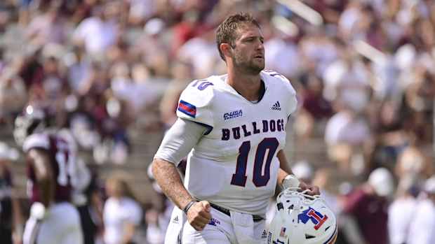 Sep 4, 2021; Starkville, Mississippi, USA; Louisiana Tech Bulldogs quarterback Austin Kendall (10) leaves the field for a down after losing his helmet during a play against the Mississippi State Bulldogs during the first quarter at Davis Wade Stadium at Scott Field. Mandatory Credit: Matt Bush-USA TODAY Sports