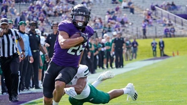 Northwestern Wildcats running back Evan Hull (26) runs the ball for a touchdown as Ohio Bobcats cornerback John Gregory (13) pursues him during the first half at Ryan Field. David Banks-USA TODAY Sports