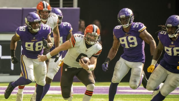 Oct 3, 2021; Minneapolis, Minnesota, USA; Cleveland Browns quarterback Baker Mayfield (6) scrambles in the third quarter against Minnesota Vikings defensive end D.J. Wonnum (98), defensive end Danielle Hunter (99) and defensive tackle Armon Watts (96) at U.S. Bank Stadium. Mandatory Credit: Matt Blewett-USA TODAY Sports