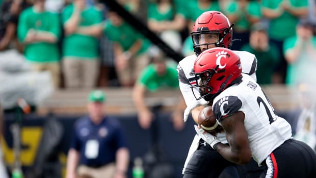 Cincinnati Bearcats quarterback Desmond Ridder (9) hands the ball to Cincinnati Bearcats running back Jerome Ford (24) in the first half of the NCAA football game between the Cincinnati Bearcats and the Notre Dame Fighting Irish on Saturday, Oct. 2, 2021, at Notre Dame Stadium in South Bend, Ind.

Cincinnati Bearcats At Notre Dame Fighting Irish 205