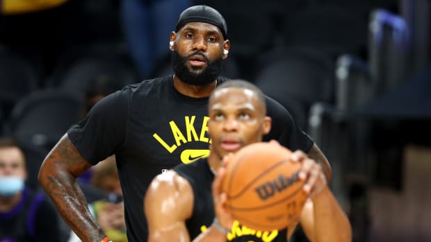 Los Angeles Lakers forward LeBron James (back) watches guard Russell Westbrook shoot prior to the preseason game against the Phoenix Suns