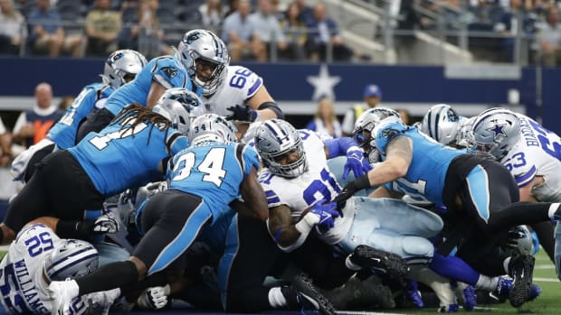 Oct 3, 2021; Arlington, Texas, USA; Dallas Cowboys running back Ezekiel Elliott (21) scores a touchdown against Carolina Panthers defensive back Sean Chandler (34) in the first quarter at AT&amp;T Stadium. Mandatory Credit: Tim Heitman-USA TODAY Sports