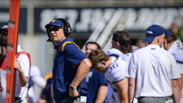 Oct 9, 2021; Waco, Texas, USA; West Virginia Mountaineers head coach Neal Brown checks the replay screen during the first half against the Baylor Bears at McLane Stadium.