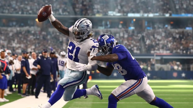 Oct 10, 2021; Arlington, Texas, USA; Dallas Cowboys running back Ezekiel Elliott (21) scores a third quarter touchdown against New York Giants linebacker Tae Crowder (48) at AT&T Stadium.