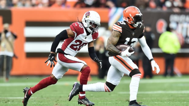 Oct 17, 2021; Cleveland, Ohio, USA; Cleveland Browns wide receiver Odell Beckham Jr. (13) runs with the ball after a catch as Arizona Cardinals cornerback Marco Wilson (20) defends during the first half at FirstEnergy Stadium. Mandatory Credit: Ken Blaze-USA TODAY Sports