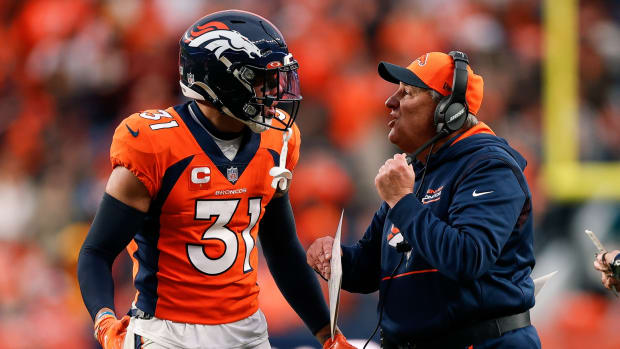 Denver Broncos head coach Vic Fangio talks with safety Justin Simmons (31) in the fourth quarter against the Washington Football Team at Empower Field at Mile High.