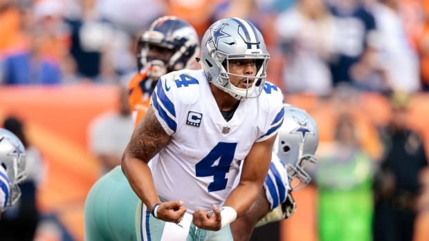 Dallas Cowboys quarterback Dak Prescott (4) gestures in the third quarter against the Denver Broncos at Sports Authority Field at Mile High.