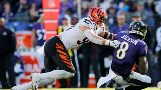 Baltimore Ravens quarterback Lamar Jackson (8) is brought down by Cincinnati Bengals defensive end Sam Hubbard (94) in the third quarter of the NFL Week 7 game between the Baltimore Ravens and the Cincinnati Bengals at M&amp;T Bank Stadium in Baltimore on Sunday, Oct. 24, 2021. The Bengals moved into the top of the AFC North with a 41-17 win over the Ravens.

Cincinnati Bengals At Baltimore Ravens Week 7