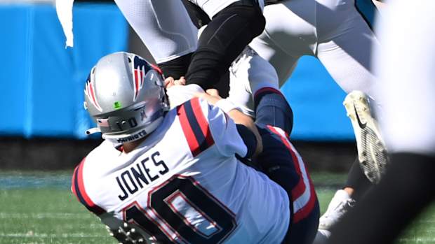 Mac Jones grabbing Brian Burns's ankle.