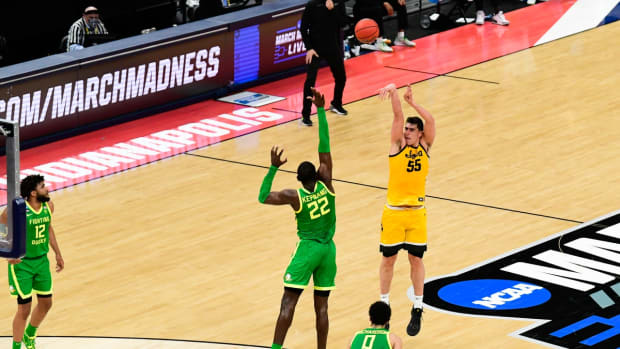 Iowa Hawkeyes center Luka Garza (55) shoots a three-pointer over Oregon Ducks center Franck Kepnang (22) during the second round of the 2021 NCAA Tournament on Monday, March 22, 2021, at Bankers Life Fieldhouse in Indianapolis, Ind. Mandatory Credit: Sam Owens/IndyStar via USA TODAY Sports
