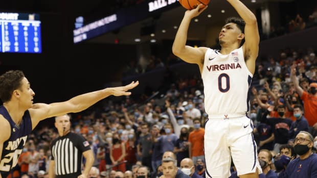 Nov 9, 2021; Charlottesville, Virginia, USA; Virginia Cavaliers guard Kihei Clark (0) shoots the ball over Navy Midshipmen guard Greg Summers (20) during the second half at John Paul Jones Arena. Mandatory Credit: Geoff Burke-USA TODAY Sports
