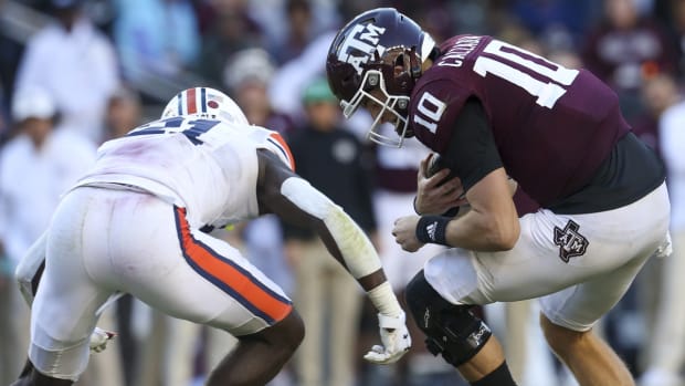 Nov 6, 2021; College Station, Texas, USA; Texas A&amp;M Aggies quarterback Zach Calzada (10) is tackled by Auburn Tigers safety Smoke Monday (21) in the second half at Kyle Field. Calzada was hurt on the play. Texas A&amp;M Aggies won 20 to 3. Mandatory Credit: Thomas Shea-USA TODAY Sports