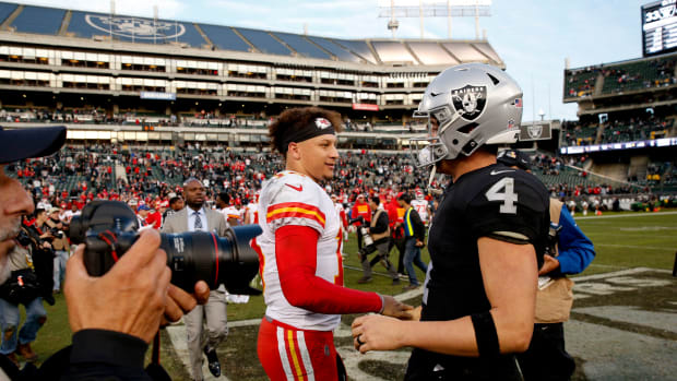Dec 2, 2018; Oakland, CA, USA; Kansas City Chiefs quarterback Patrick Mahomes (15) meets with Oakland Raiders quarterback Derek Carr (4) after the game at Oakland Coliseum. Mandatory Credit: Cary Edmondson-USA TODAY Sports