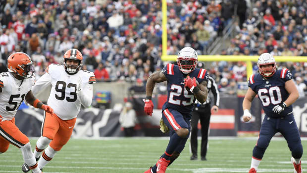 Nov 14, 2021; New England Patriots running back Brandon Bolden (25) runs with the ball while Cleveland Browns outside linebacker Mack Wilson (51) and defensive tackle Tommy Togiai (93) gives chase during the second half at Gillette Stadium. Foxborough, Massachusetts, USA; Mandatory Credit: Bob DeChiara-USA TODAY Sports