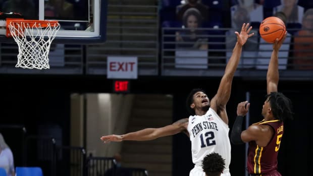 Mar 3, 2021; University Park, Pennsylvania, USA; Penn State Nittany Lions guard Izaiah Brockington (12) defends as Minnesota Golden Gophers guard Marcus Carr (5) shoots the ball during the second half at Bryce Jordan Center. Penn State State defeated Minnesota 84-65. Mandatory Credit: Matthew OHaren-USA TODAY Sports