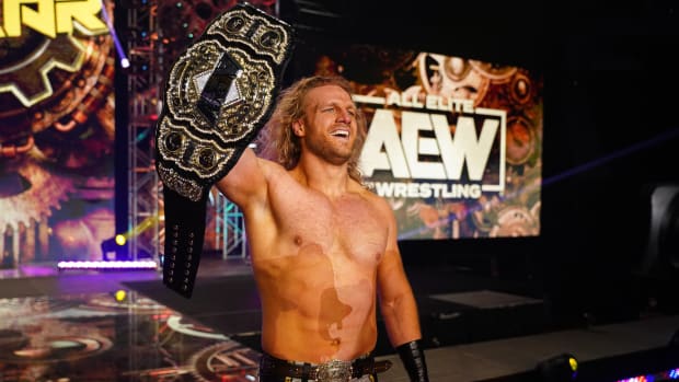 Hangman Adam Page celebrates with the AEW world championship