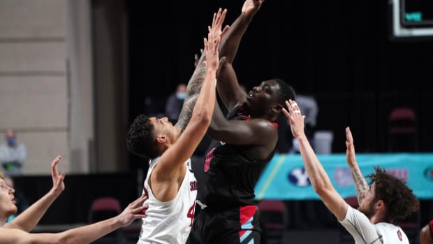 Mar 6, 2021; Las Vegas, NV, USA; Loyola Marymount Lions guard Eli Scott (0) shoots the ball over St. Mary's Gaels forward Dan Fotu (42) in the second half at Orleans Arena. St. Mary's won 52-47. Mandatory Credit: Kirby Lee-USA TODAY Sports