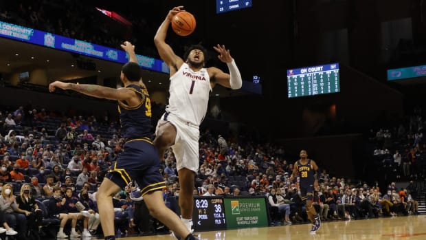 Nov 19, 2021; Charlottesville, Virginia, USA; Virginia Cavaliers forward Jayden Gardner (1) is fouled while driving to the basket by Coppin State Eagles guard Jesse Zarzuela (50) during the second half at John Paul Jones Arena. Mandatory Credit: Geoff Burke-USA TODAY Sports