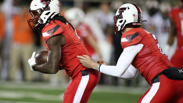 Nov 20, 2021; Lubbock, Texas, USA; Texas Tech Red Raiders quarterback Behren Morton (2) hands the ball in the second half to running back SaRodorick Thompson (4) against the Oklahoma State Cowboys in the game at Jones AT&amp;T Stadium. Mandatory Credit: Michael C. Johnson-USA TODAY Sports