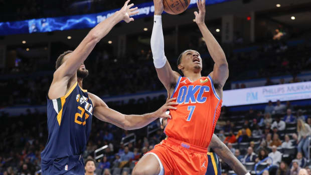 Nov 24, 2021; Oklahoma City, Oklahoma, USA; Oklahoma City Thunder forward Darius Bazley (7) goes to the basket as Utah Jazz center Rudy Gobert (27) defends the shot during the first half at Paycom Center. Mandatory Credit: Alonzo Adams-USA TODAY Sports