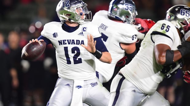 Nov 13, 2021; Carson, California, USA; Nevada Wolf Pack quarterback Carson Strong (12) throws as offensive lineman Aaron Frost (65) and offensive lineman Tyler Orsini (55) provide coverage against the San Diego State Aztecs defense during the first half at Dignity Health Sports Park. Mandatory Credit: Gary A. Vasquez-USA TODAY Sports