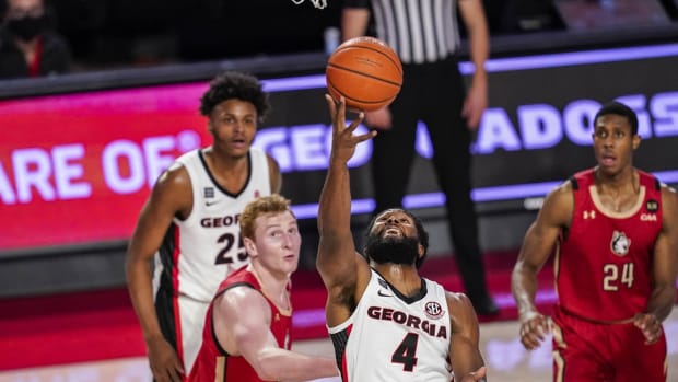 Dec 22, 2020; Athens, Georgia, USA; Georgia Bulldogs forward Andrew Garcia (4) shoots against Northeastern Huskies forward Chris Doherty (33) during the first half at Stegeman Coliseum. Mandatory Credit: Dale Zanine-USA TODAY Sports