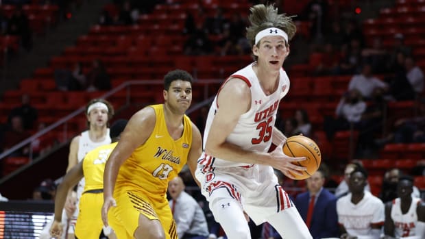 Nov 15, 2021; Salt Lake City, Utah, USA; Utah Utes center Branden Carlson (35) drives past Bethune-Cookman Wildcats forward Calvin Poulina (13) in the second half at Jon M. Huntsman Center. Mandatory Credit: Jeffrey Swinger-USA TODAY Sports