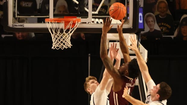 Mar 6, 2021; Richmond, Virginia, USA; Fordham Rams forward Chuba Ohams (1) shoots the ball as George Washington Colonials forward Hunter Dean (13) defends in the first half in the first round of the 2021 Atlantic 10 Conference Tournament at at Stuart C. Siegel Center. Mandatory Credit: Geoff Burke-USA TODAY Sports