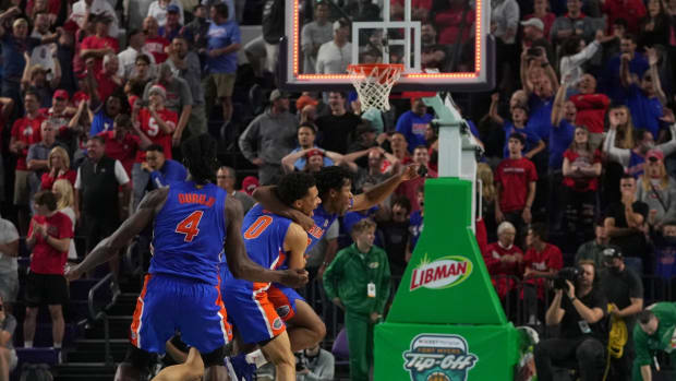 Nov 24, 2021; Fort Myers, Florida, USA; Florida Gators guard Tyree Appleby (22) celebrates with guard Myreon Jones (0) and forward Anthony Duruji (4) after making a three point buzzer beater shot to defeat the Ohio State Buckeyes at Suncoast Credit Union Arena. Mandatory Credit: Jasen Vinlove-USA TODAY Sports