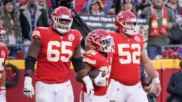 Nov 21, 2021; Kansas City, Missouri, USA; Kansas City Chiefs running back Clyde Edwards-Helaire (25) celebrates with guard Trey Smith (65) and center Creed Humphrey (52) after scoring against the Dallas Cowboys during the first half at GEHA Field at Arrowhead Stadium. Mandatory Credit: Denny Medley-USA TODAY Sports