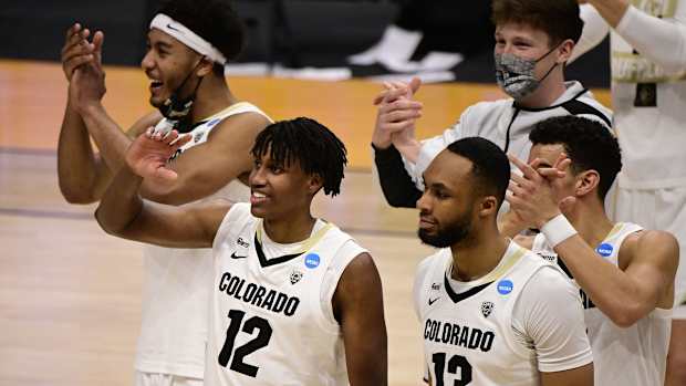 Mar 20, 2021; Indianapolis, Indiana, USA; Colorado Buffaloes players including Jabari Walker (12) and Dallas Walton (13) celebrate after defeating the Georgetown Hoyas during the first round of the 2021 NCAA Tournament at Hinkle Fieldhouse. Mandatory Credit: Marc Lebryk-USA TODAY Sports