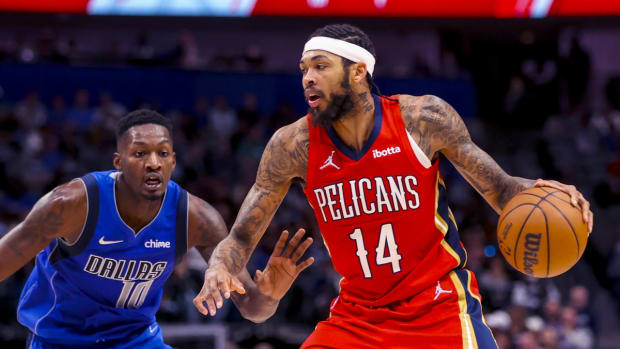 Dec 3, 2021; Dallas, Texas, USA; New Orleans Pelicans forward Brandon Ingram (14) dribbles as Dallas Mavericks forward Dorian Finney-Smith (10) defends during the first half at American Airlines Center. Mandatory Credit: Kevin Jairaj-USA TODAY Sports