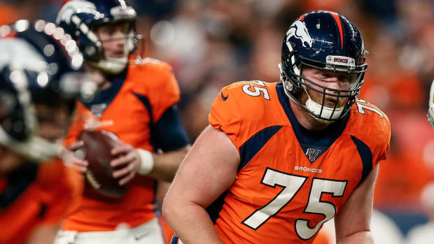 Denver Broncos offensive tackle Quinn Bailey (75) guards Arizona Cardinals linebacker Vontarrius Dora (54) in the second quarter at Broncos Stadium at Mile High.