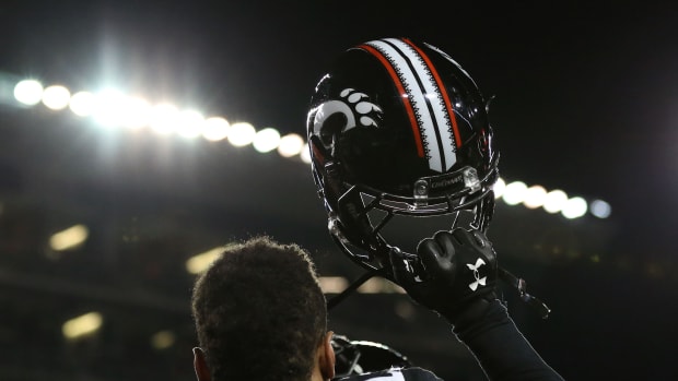Nov 14, 2015; Cincinnati, OH, USA; Cincinnati Bearcats linebacker Eric Wilson (23) holds up his helmet after defeating the Tulsa Golden Hurricane 49-38 at Nippert Stadium. Mandatory Credit: Aaron Doster-USA TODAY Sports