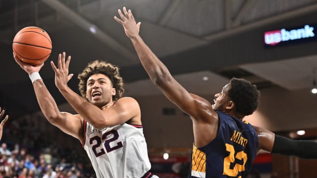 Dec 9, 2021; Spokane, Washington, USA; Gonzaga Bulldogs forward Anton Watson, left, shoots the ball against Merrimack Warriors forward Jordan Minor (22) in the first half at McCarthey Athletic Center. Mandatory Credit: James Snook-USA TODAY Sports