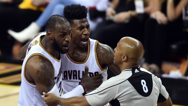 LeBron James and Iman Shumpert speaking with an official.
