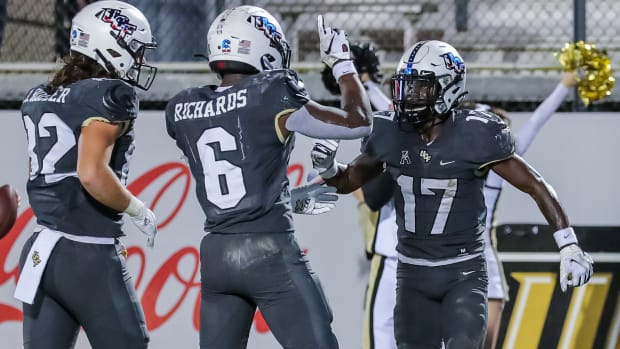 Nov 20, 2021; Orlando, Florida, USA; UCF Knights wide receiver Amari Johnson (17) celebrates his touchdown with running back Mark-Antony Richards (6) and tight end Alec Holler (82) against the Connecticut Huskies during the second half at Bounce House.